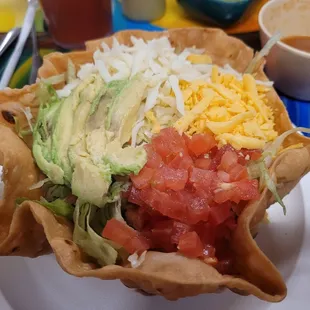 Yummy taco salad with beef and a generous heap of toppings.