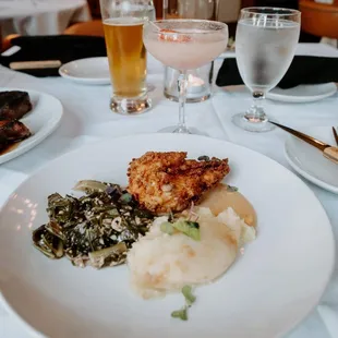 The delicious Charleston Fried Chicken comes with pomme puree, collard greens, and black pepper gravy.