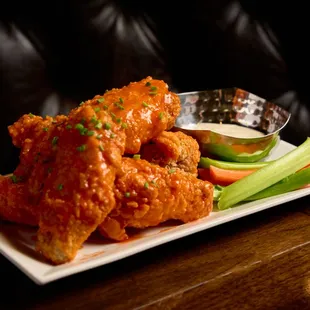 Spicy, crispy hot wings with a fiery kick that&apos;ll satisfy your craving for heat and flavor.