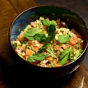 A fresh, vibrant Mediterranean salad, loaded with crisp veggies, olives, and a zesty dressing.