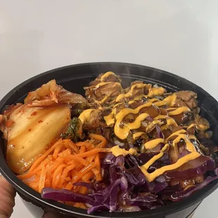 a person holding a bowl of food