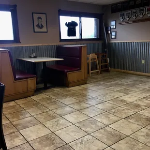 a dining area with tables and booths