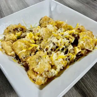 a square white plate of food