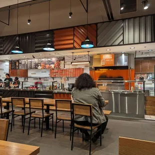 a woman sitting at a table in a restaurant