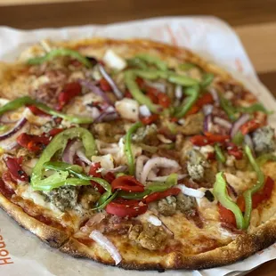 a pizza on a piece of wax paper