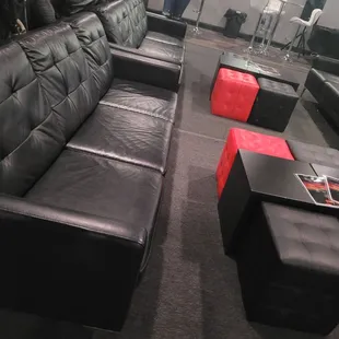 a black leather sofa and ottoman