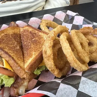 Grilled chicken club sandwich with hand breaded onion rings