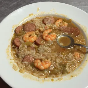 a bowl of soup with shrimp and sausage