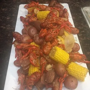 a platter of boiled cajuns, corn and potatoes