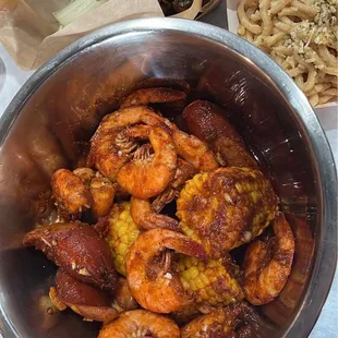 Headless shrimp with corn and sausages blazing spice level. Wings in house sauce and garlic noodles.