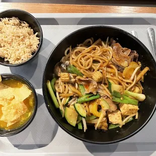 Large bowl with brown rice and soup topped with crispy wonton strips