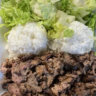a plate of rice and lettuce