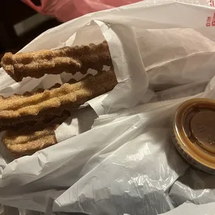 a bag of churros and a cup of coffee