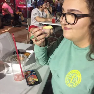 a woman eating a hot dog
