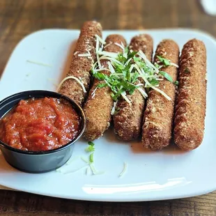 Golden Fried Mozzarella - Crispy seasoned mozzarella sticks served with vine ripened marinara sauce