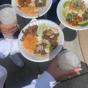 Al Pastor, Chicken, and Asada tacos with rice &amp; beans and all the toppings. Delicious!