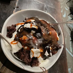 Brownie with triple chocolate brownie, homemade whipped cream, ganache and caramel drizzle.