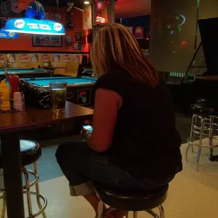 a woman sitting at a bar