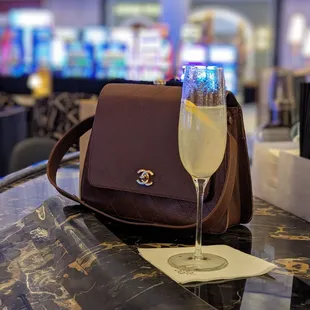 a glass of wine and a purse