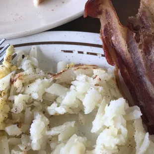 Dried out bacon and steamed potatoes.