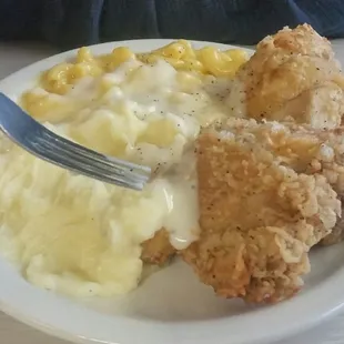 Buffet with fried chicken, mashed potatoes, and macaroni and cheese.