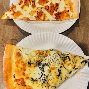 two slices of pizza on paper plates