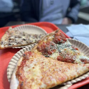 two slices of pizza on a paper plate