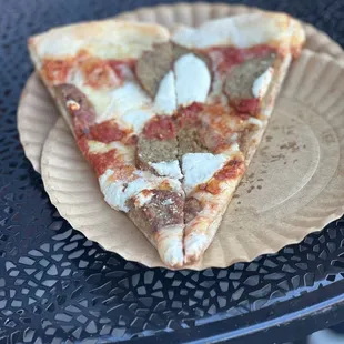 two slices of pizza on a paper plate