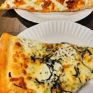 two slices of pizza on paper plates