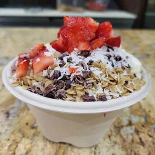 a bowl of cereal with strawberries and chocolate