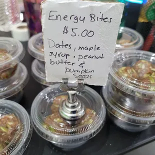 Energy bites, date balls in small plastic containers.