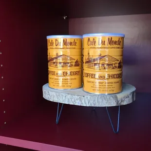 three cans of coffee on a shelf