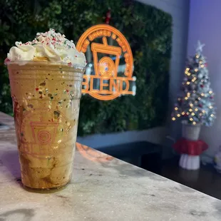 a cup of iced coffee with whipped cream and sprinkles