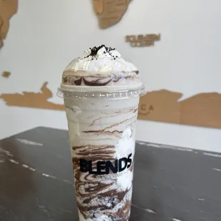 a cup of coffee with whipped cream and chocolate