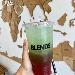 a hand holding a drink