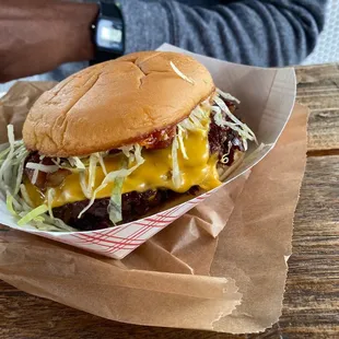 a hamburger with cheese and lettuce