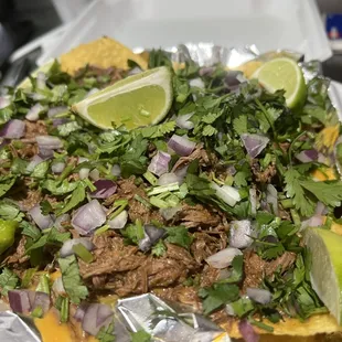 a plate of beef nachos
