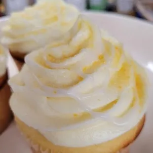 a plate of cupcakes with frosting