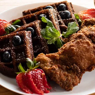 a plate of waffles and strawberries