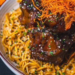 Most popular dish! Sweet Garlic Oxtails over a bed of Garlic Noodles