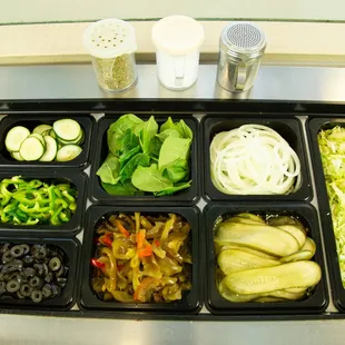 a variety of vegetables in trays