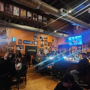 people sitting at tables in a bar