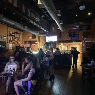 people sitting at tables in a bar
