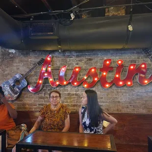 My work peeps infront of the ATX sign inside