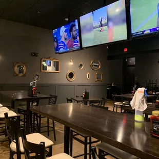 a sports bar with multiple screens