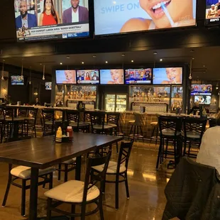 a restaurant with multiple television screens