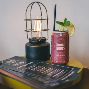 a can of beer and a menu on a table