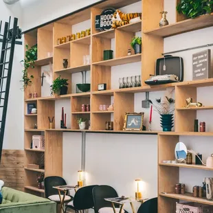 a living room with shelves and a ladder