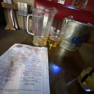 a menu and a pitcher of beer