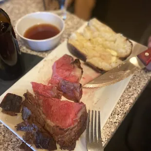 a plate of steak and bread